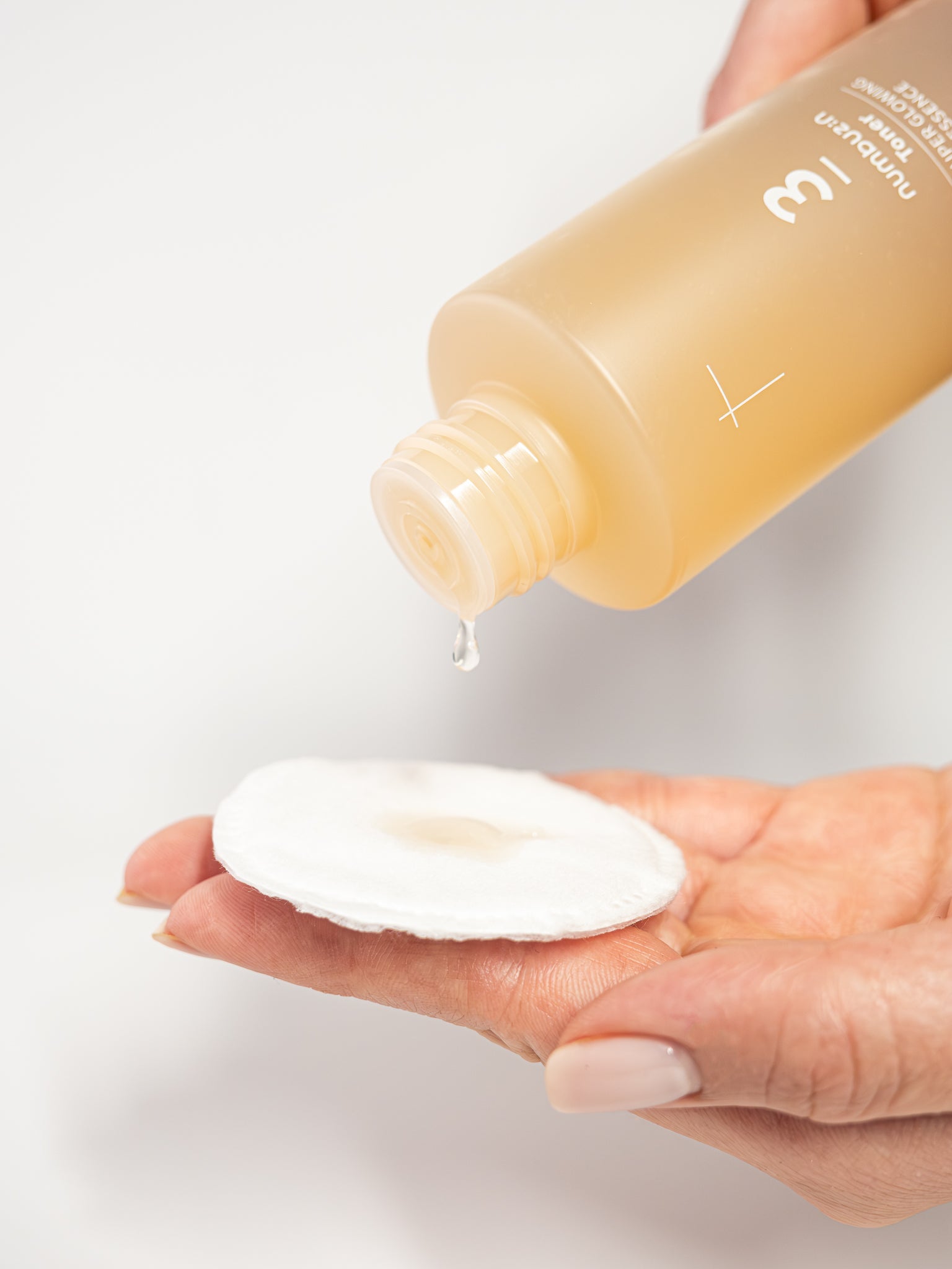numbuzin no3 super glowing essence toner poured on to a cotton pad