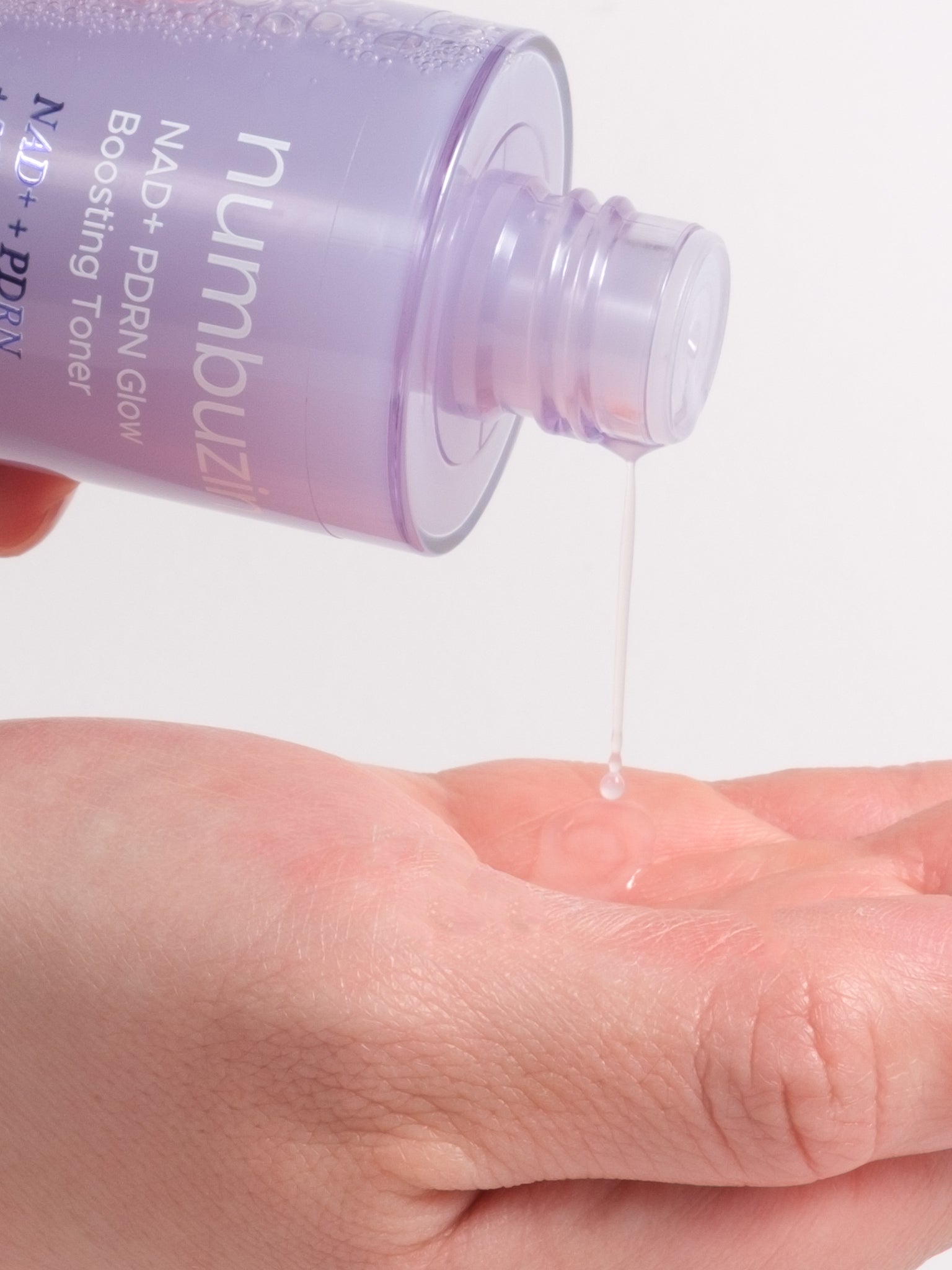 numbuzin No.9 NAD+ PDRN Glow Boosting Toner being pressed into skin for a dewy glow