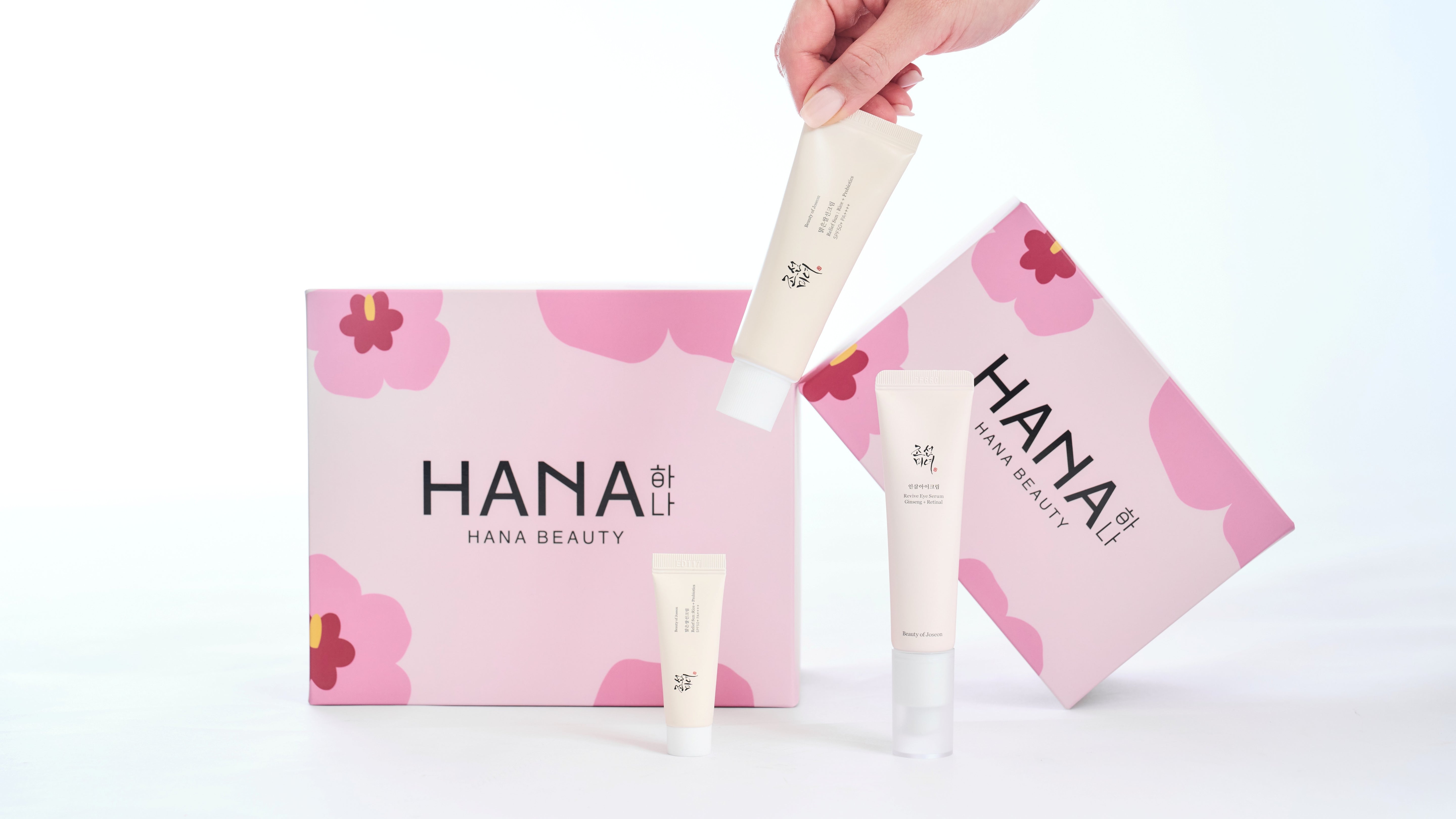 Hana Beauty product set with pink floral packaging on a white background