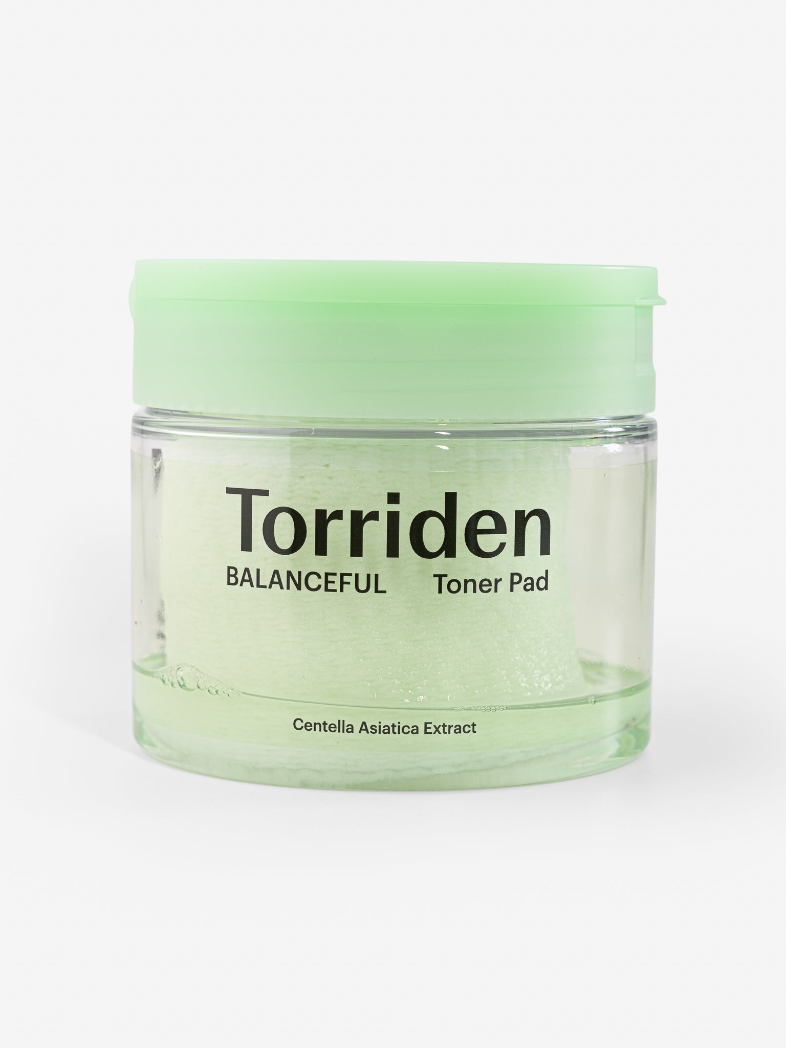Torriden Balanceful Toner Pad jar with green lid on a white background