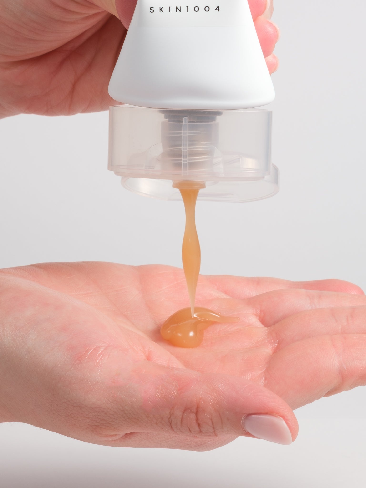 SKIN1004 Madagascar Centella Soothing Cream squeezed as an amber gel into a palm