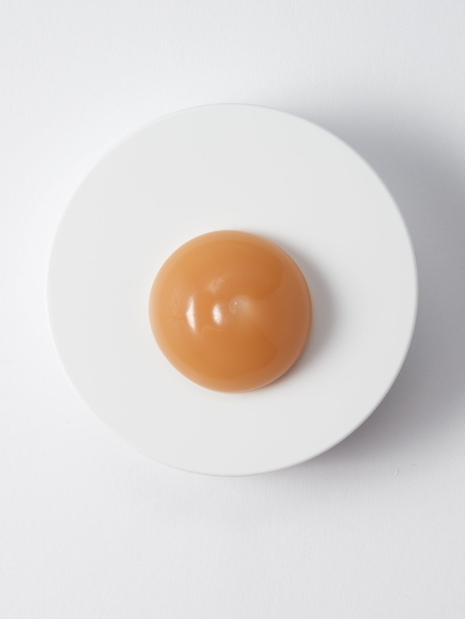 Amber gel texture of SKIN1004 Madagascar Centella Soothing Cream on a white dish