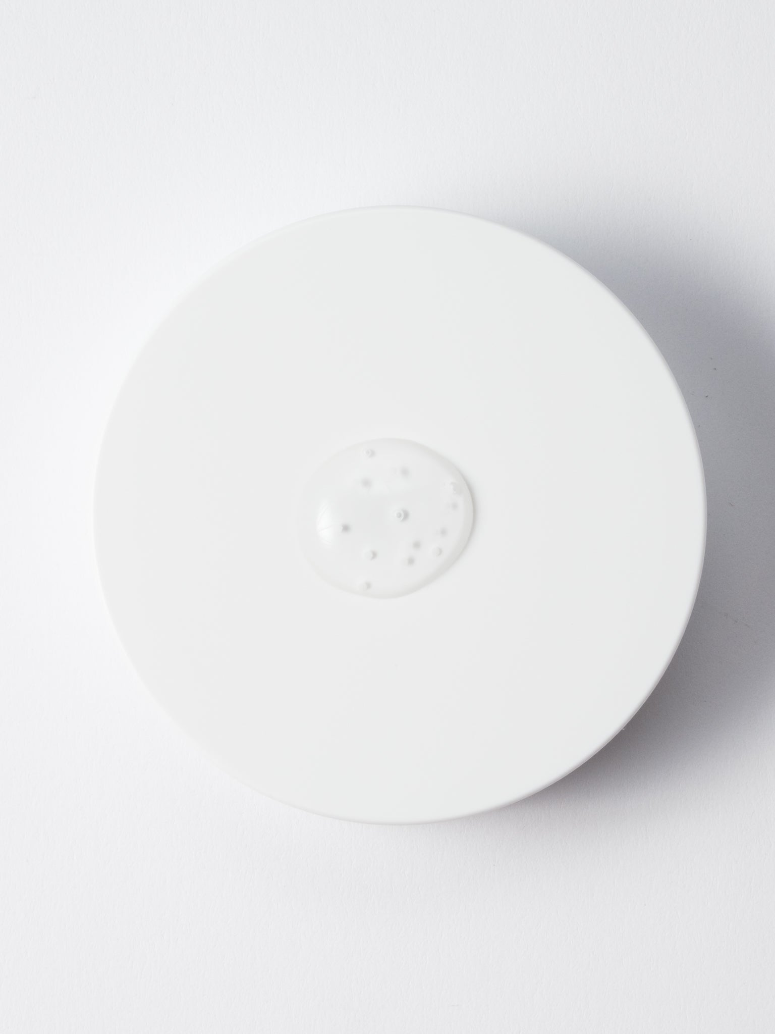 Close-up of SKIN1004 Tone Brightening Capsule Ampoule texture with encapsulated micro-beads